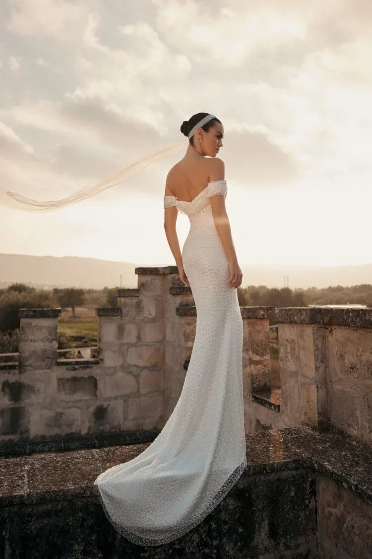 Elegant Minimalist Sheath Wedding Dress with Strapless Off-Shoulder Neckline, Glitter Embellishments, and Natural Waistline for a Stunning Bridal Look